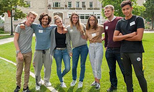 a group of diverse young people posing for a picture.